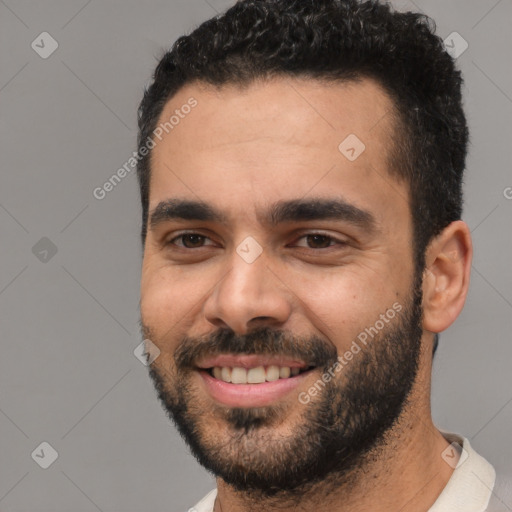 Joyful white young-adult male with short  black hair and brown eyes