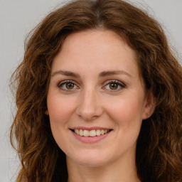 Joyful white young-adult female with long  brown hair and green eyes