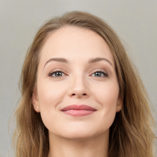 Joyful white young-adult female with long  brown hair and grey eyes