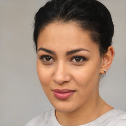 Joyful latino young-adult female with short  brown hair and brown eyes