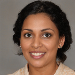 Joyful black young-adult female with medium  brown hair and brown eyes