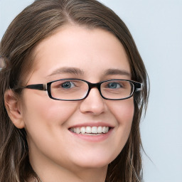 Joyful white young-adult female with long  brown hair and blue eyes