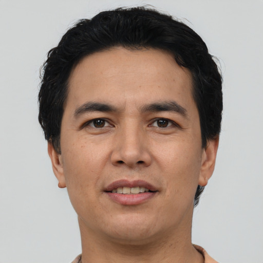 Joyful asian adult male with short  black hair and brown eyes