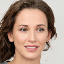 Joyful white young-adult female with long  brown hair and blue eyes