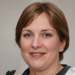 Joyful white adult female with medium  brown hair and blue eyes