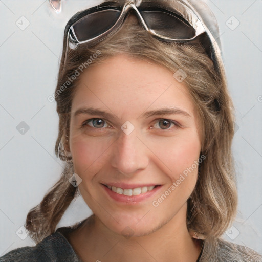 Joyful white young-adult female with medium  brown hair and blue eyes