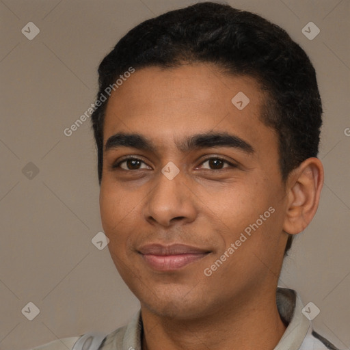 Joyful latino young-adult male with short  black hair and brown eyes