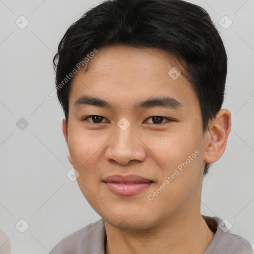 Joyful asian young-adult male with short  black hair and brown eyes