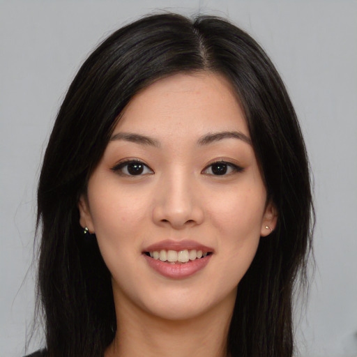 Joyful asian young-adult female with long  black hair and brown eyes