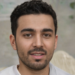 Joyful white young-adult male with short  black hair and brown eyes