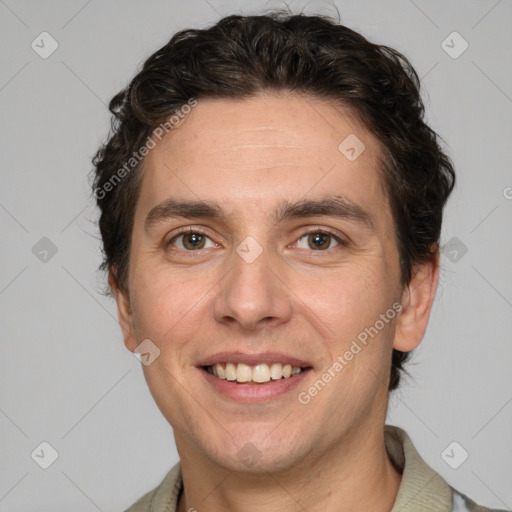 Joyful white adult male with short  brown hair and grey eyes