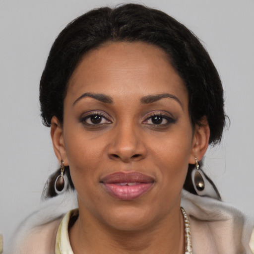 Joyful black young-adult female with medium  brown hair and brown eyes