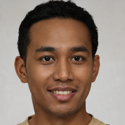 Joyful latino young-adult male with short  black hair and brown eyes