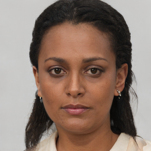Neutral black adult female with long  brown hair and brown eyes