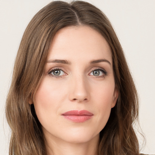 Joyful white young-adult female with long  brown hair and green eyes