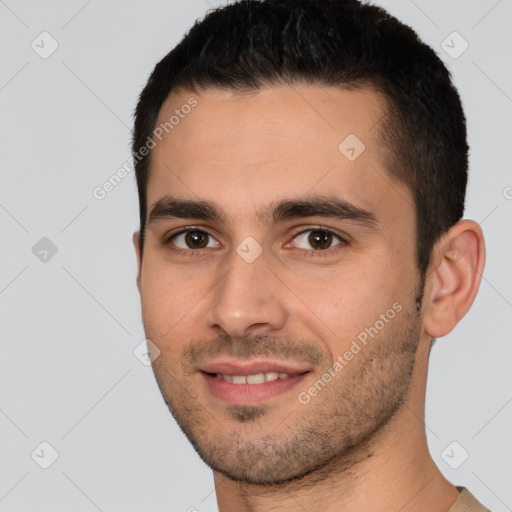 Joyful white young-adult male with short  black hair and brown eyes