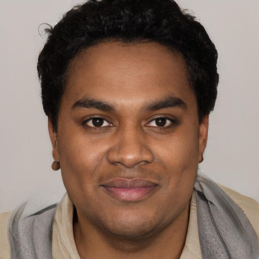 Joyful black young-adult male with short  black hair and brown eyes