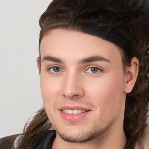 Joyful white young-adult male with medium  brown hair and brown eyes