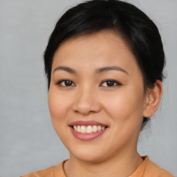 Joyful asian young-adult female with short  brown hair and brown eyes