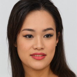 Joyful asian young-adult female with long  brown hair and brown eyes