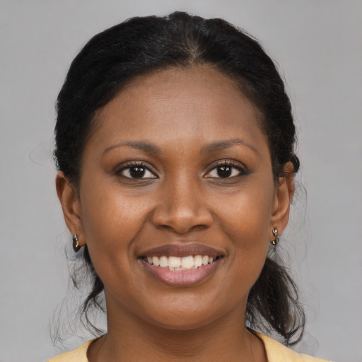 Joyful black young-adult female with medium  brown hair and brown eyes