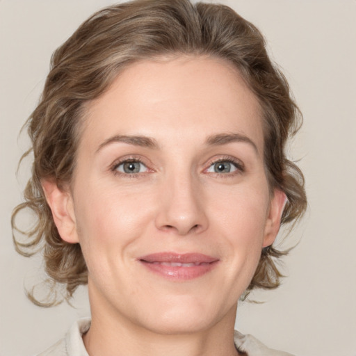 Joyful white adult female with medium  brown hair and grey eyes