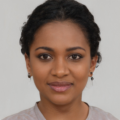 Joyful black young-adult female with short  black hair and brown eyes