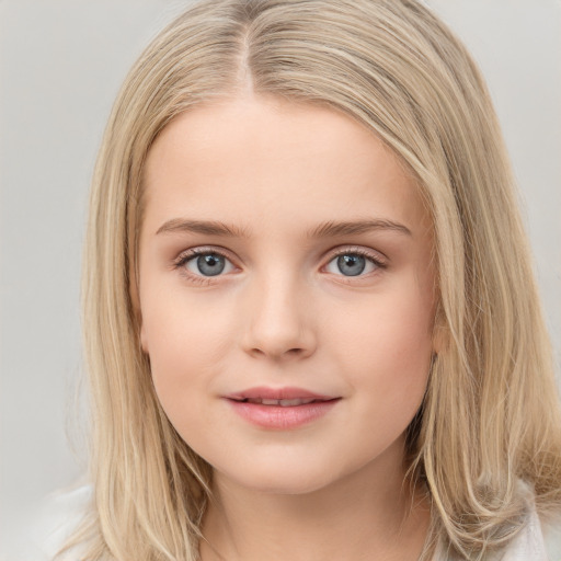 Joyful white child female with long  brown hair and blue eyes