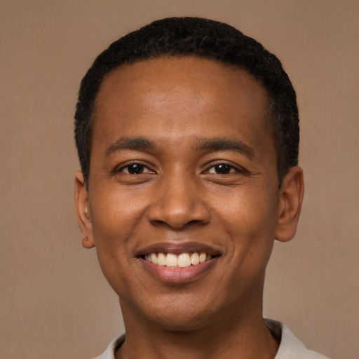 Joyful black young-adult male with short  black hair and brown eyes