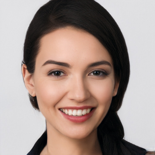 Joyful white young-adult female with long  black hair and brown eyes