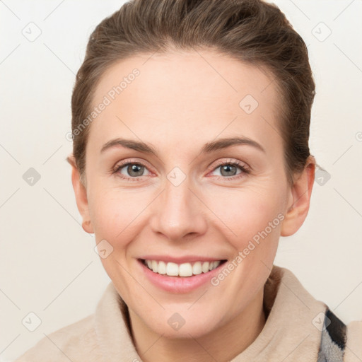 Joyful white young-adult female with short  brown hair and grey eyes