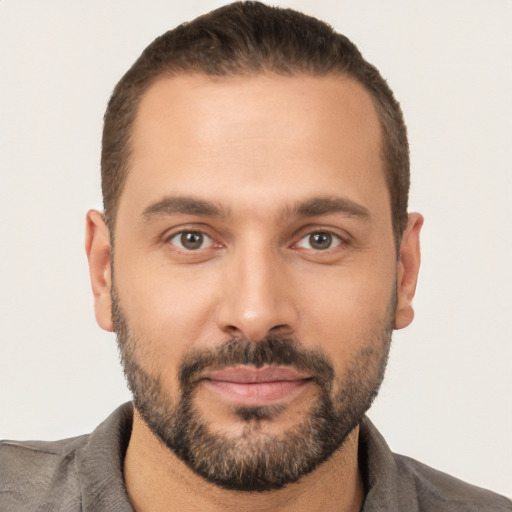 Joyful white young-adult male with short  brown hair and brown eyes