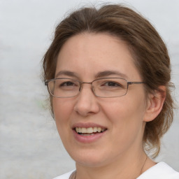 Joyful white adult female with medium  brown hair and brown eyes