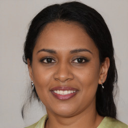 Joyful black young-adult female with medium  brown hair and brown eyes