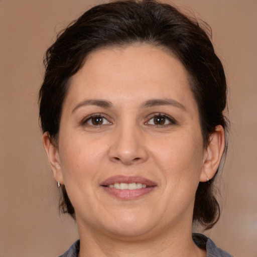 Joyful white adult female with medium  brown hair and brown eyes