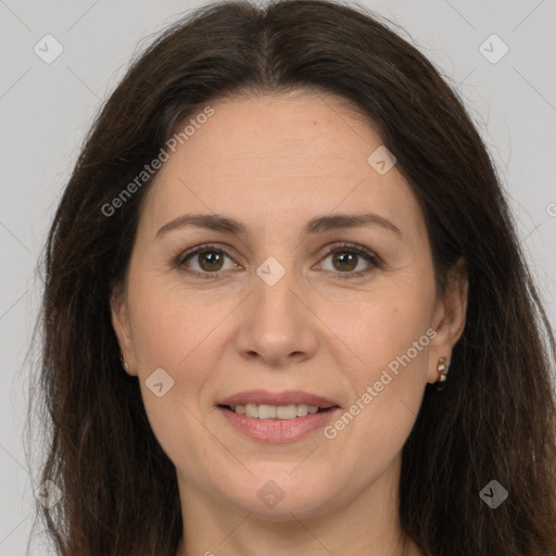 Joyful white adult female with long  brown hair and brown eyes