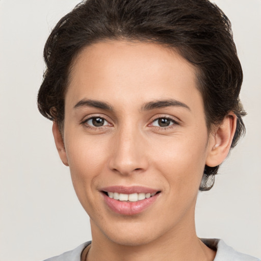 Joyful white young-adult female with short  brown hair and brown eyes