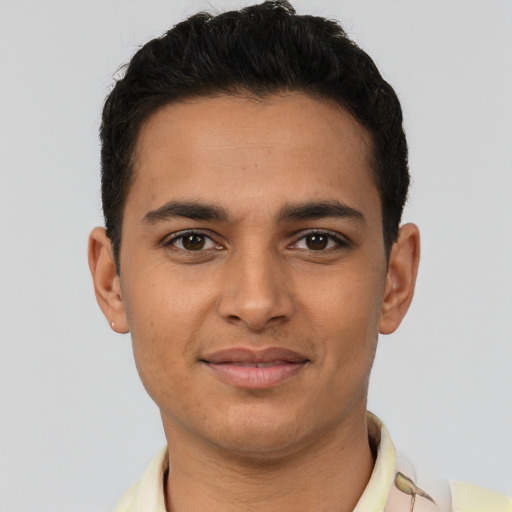 Joyful latino young-adult male with short  brown hair and brown eyes