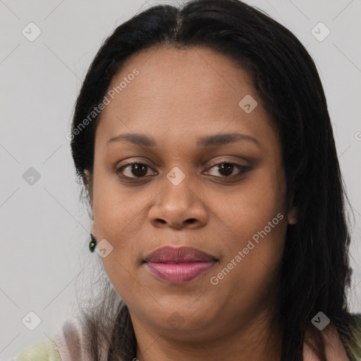 Joyful black young-adult female with long  brown hair and brown eyes
