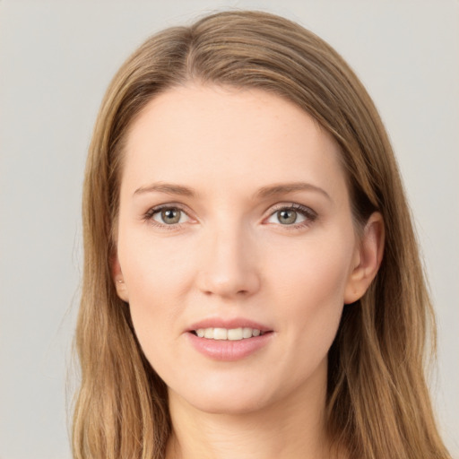 Joyful white young-adult female with long  brown hair and grey eyes