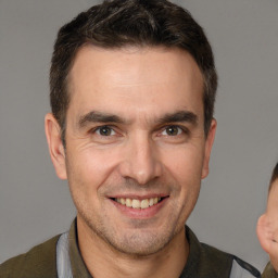 Joyful white adult male with short  brown hair and brown eyes