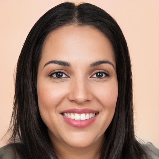 Joyful white young-adult female with long  black hair and brown eyes