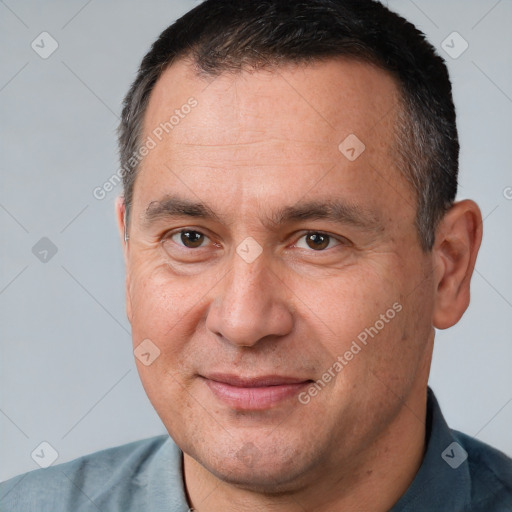 Joyful white adult male with short  brown hair and brown eyes