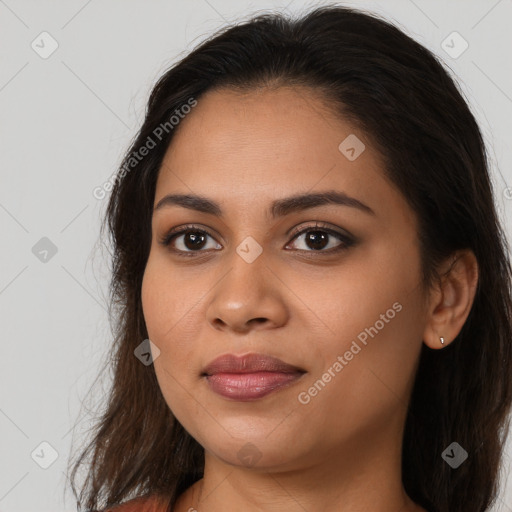 Joyful latino young-adult female with long  brown hair and brown eyes