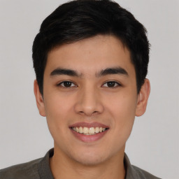 Joyful asian young-adult male with short  black hair and brown eyes