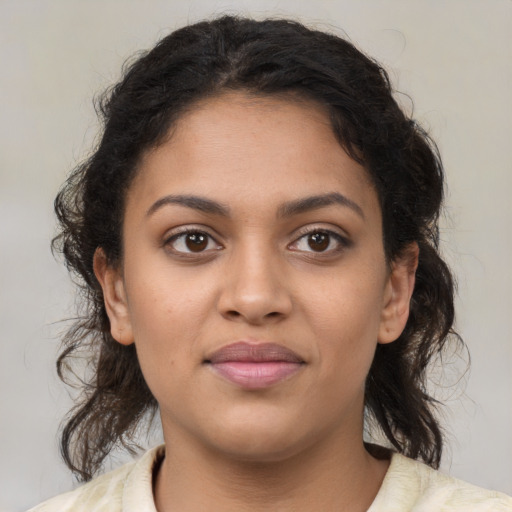 Joyful latino young-adult female with medium  brown hair and brown eyes