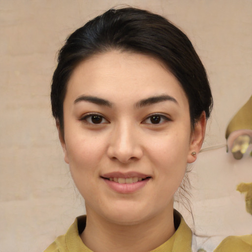 Joyful asian young-adult female with medium  black hair and brown eyes