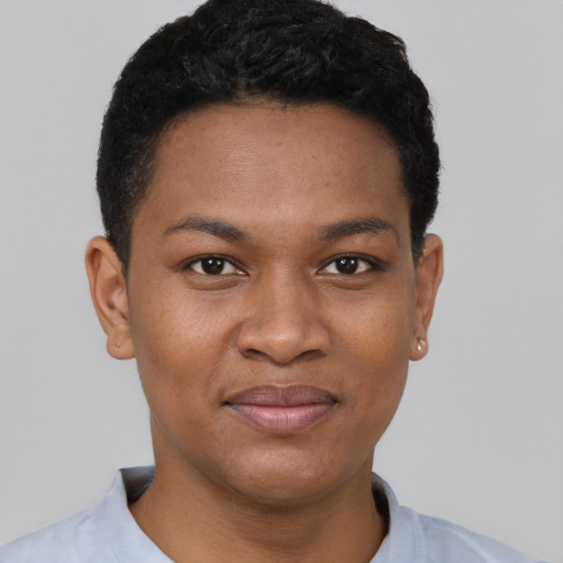 Joyful black young-adult female with short  black hair and brown eyes