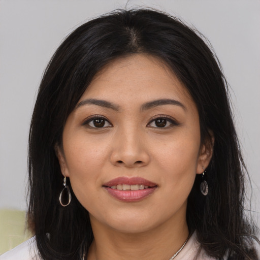 Joyful asian young-adult female with long  brown hair and brown eyes