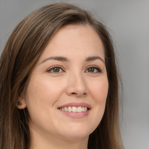 Joyful white young-adult female with long  brown hair and brown eyes